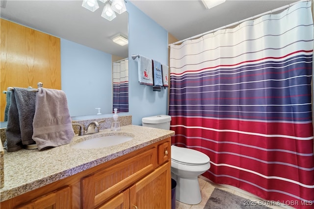 bathroom with vanity, tile patterned floors, and toilet