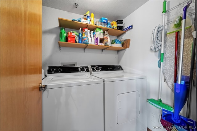 clothes washing area featuring washing machine and clothes dryer and a textured ceiling