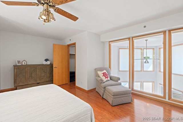 bedroom with wood finished floors, ceiling fan, and baseboards