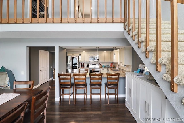 kitchen featuring tasteful backsplash, stainless steel appliances, dark hardwood / wood-style floors, and sink