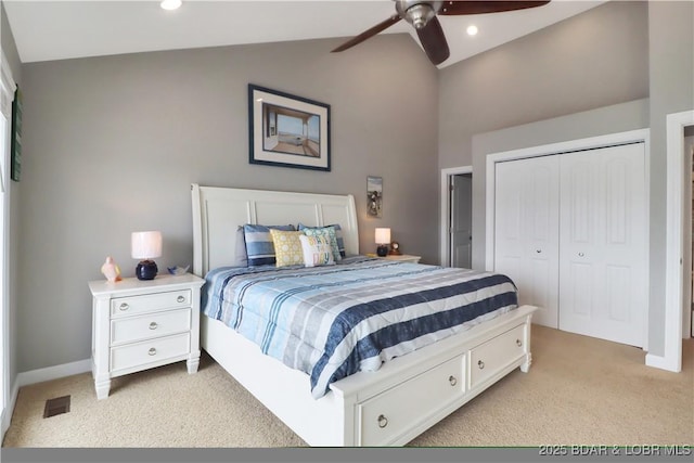 carpeted bedroom with lofted ceiling, a closet, and ceiling fan