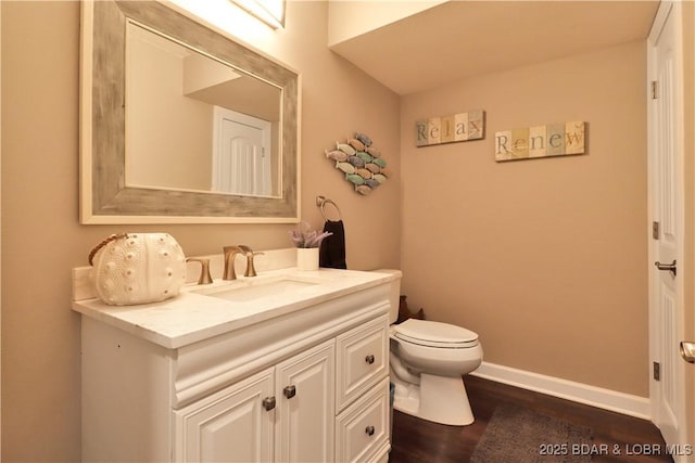 bathroom featuring vanity, hardwood / wood-style floors, and toilet