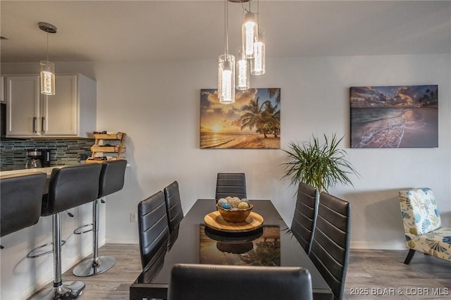 dining space with wood-type flooring