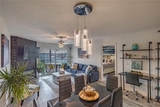 living room featuring ceiling fan and light wood-type flooring