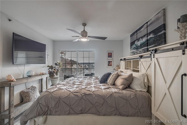 bedroom with a barn door and ceiling fan