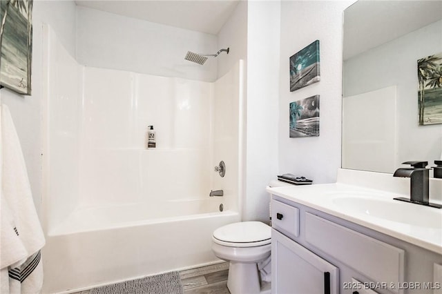 full bathroom featuring shower / bath combination, vanity, wood-type flooring, and toilet