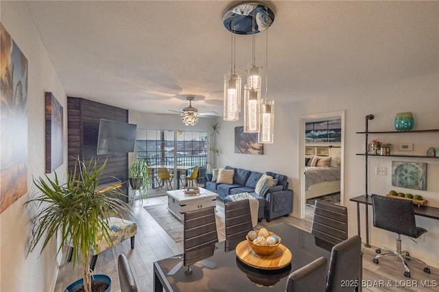 living room with ceiling fan and light hardwood / wood-style floors