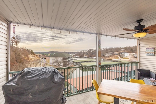 balcony at dusk featuring area for grilling and ceiling fan