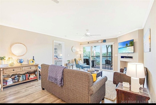 living room featuring crown molding, ceiling fan, and light hardwood / wood-style floors