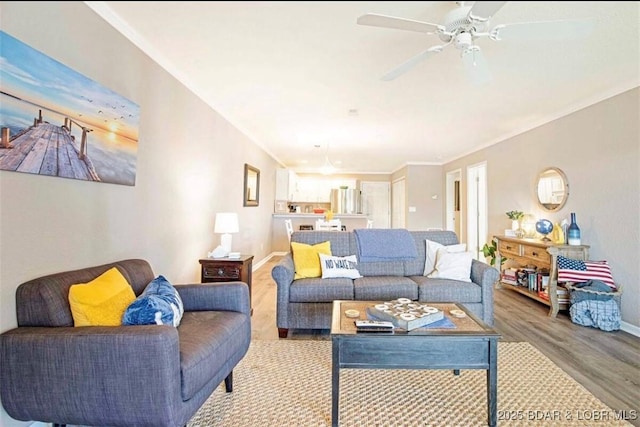 living room with crown molding, hardwood / wood-style floors, and ceiling fan