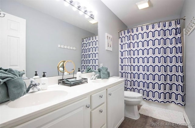 bathroom with vanity, hardwood / wood-style floors, toilet, and walk in shower