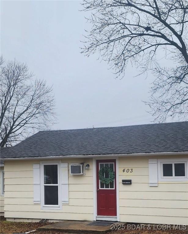 doorway to property featuring an AC wall unit