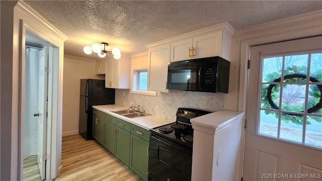 kitchen with green cabinets, black appliances, a sink, white cabinetry, and light countertops
