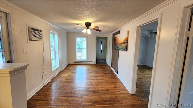 entryway featuring dark wood finished floors, a ceiling fan, baseboard heating, a textured ceiling, and ornamental molding