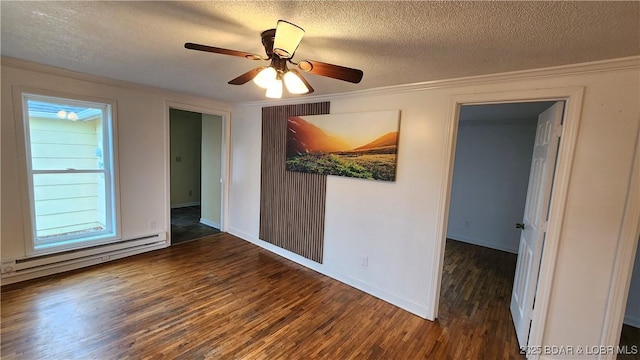 unfurnished room featuring a baseboard heating unit, wood finished floors, a textured ceiling, crown molding, and ceiling fan