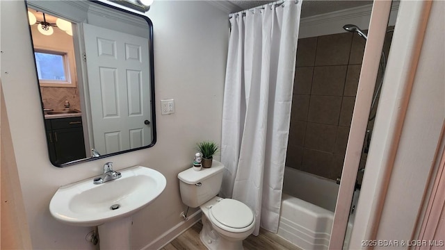 full bath with a sink, toilet, shower / tub combo, and wood finished floors