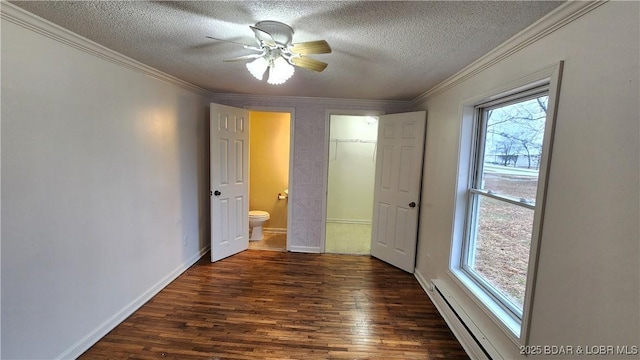 unfurnished bedroom featuring wood finished floors, a textured ceiling, crown molding, a baseboard heating unit, and connected bathroom