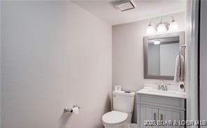 bathroom with vanity and toilet