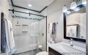 bathroom featuring walk in shower, vanity, and toilet