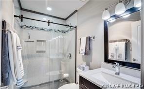 33 Crow Ct Unit 2E, Lake Ozark, MO 65049 - full bathroom featuring a shower stall, vanity, and toilet