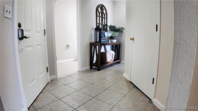 hall with light tile patterned floors