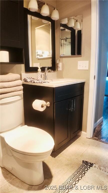 bathroom with tile patterned floors, vanity, and toilet