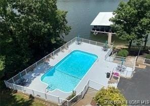 view of pool with a water view and a patio area