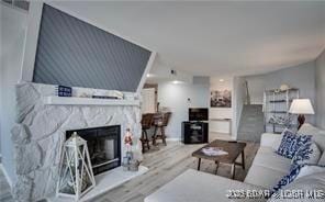 living room featuring hardwood / wood-style flooring and a fireplace