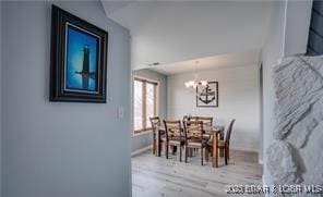 33 Crow Ct Unit 2E, Lake Ozark, MO 65049 - dining area featuring a chandelier and wood finished floors