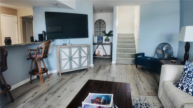 33 Crow Ct Unit 2E, Lake Ozark, MO 65049 - living area featuring wood finished floors, stairs, and baseboards