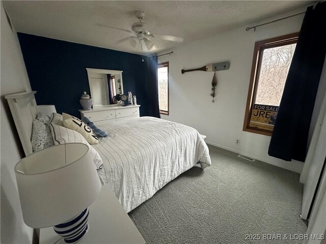 33 Crow Ct Unit 2E, Lake Ozark, MO 65049 - bedroom with light colored carpet, a ceiling fan, and a textured ceiling