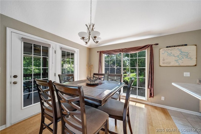 dining room with an inviting chandelier and light wood-type flooring