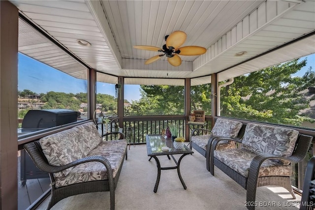 sunroom / solarium with wooden ceiling and ceiling fan