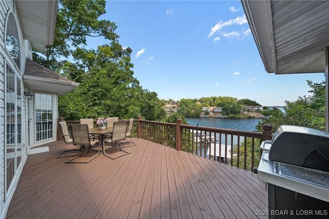 wooden deck with a water view and grilling area