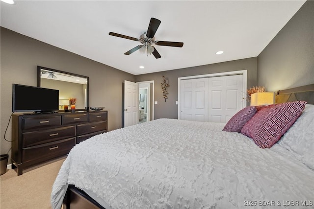 carpeted bedroom featuring ceiling fan and a closet