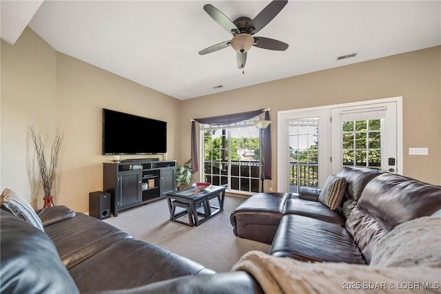 carpeted living room with ceiling fan and a healthy amount of sunlight