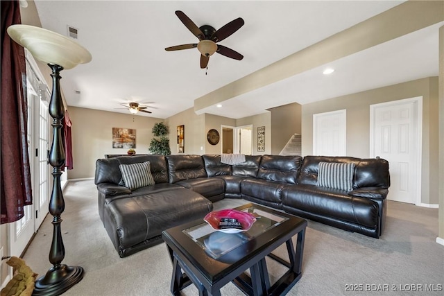 carpeted living room with ceiling fan