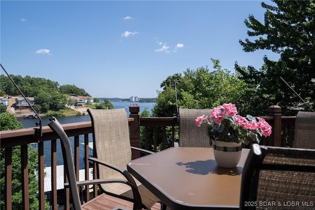 wooden terrace featuring a water view