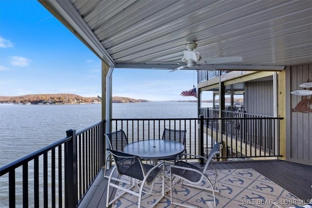 wooden deck featuring a water view and ceiling fan