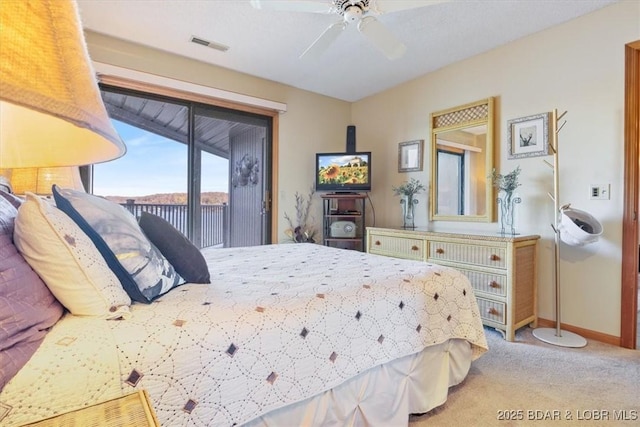 bedroom featuring access to outside, ceiling fan, and carpet flooring