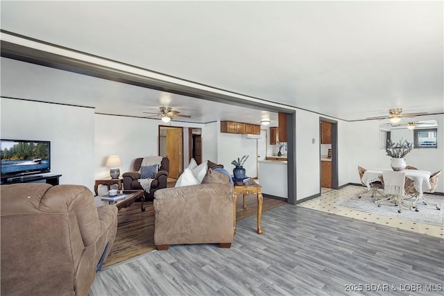 living room featuring light hardwood / wood-style floors and ceiling fan