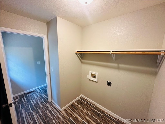 laundry area featuring electric dryer hookup, dark wood-type flooring, washer hookup, and a textured ceiling