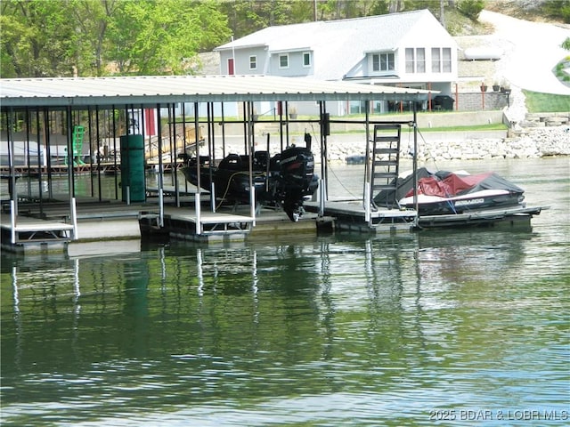 dock area with boat lift and a water view