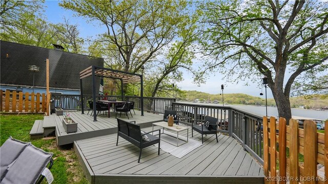 wooden terrace featuring an outdoor hangout area and a pergola