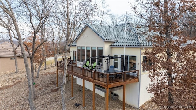 rear view of property featuring a deck