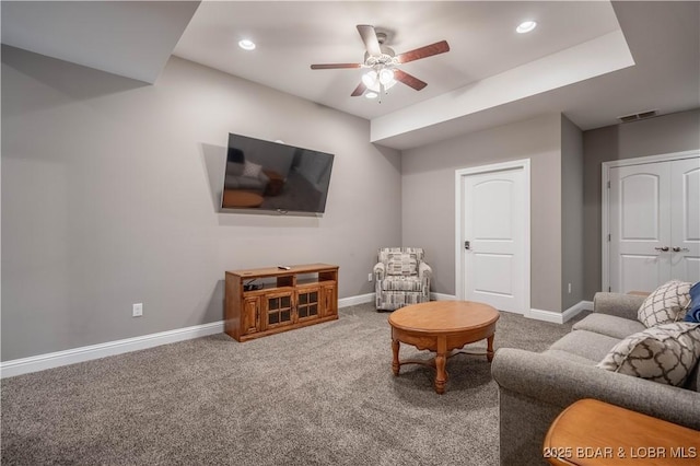 carpeted living room featuring ceiling fan