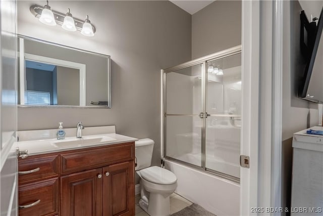 full bathroom with vanity, toilet, and combined bath / shower with glass door