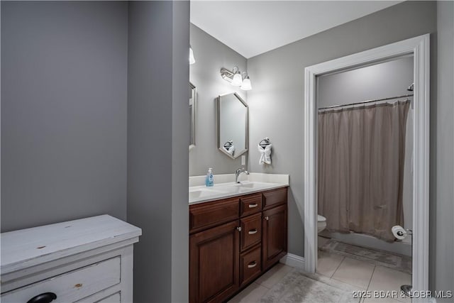 bathroom with tile patterned flooring, vanity, and toilet