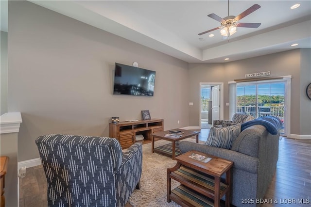 living room featuring hardwood / wood-style flooring and ceiling fan