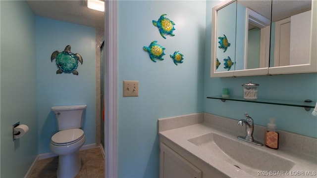 bathroom featuring tile patterned floors, vanity, toilet, and a textured ceiling